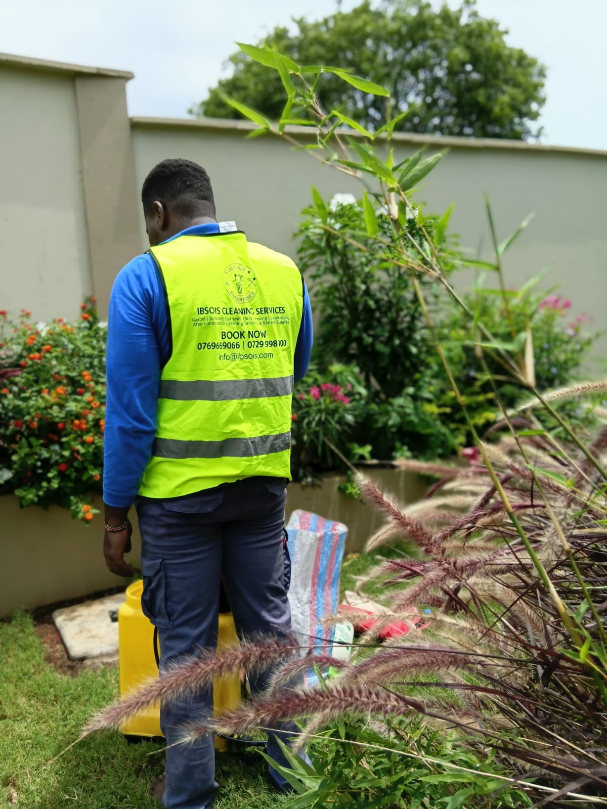 Ibsois team member preparing garden treatment equipment in Mombasa