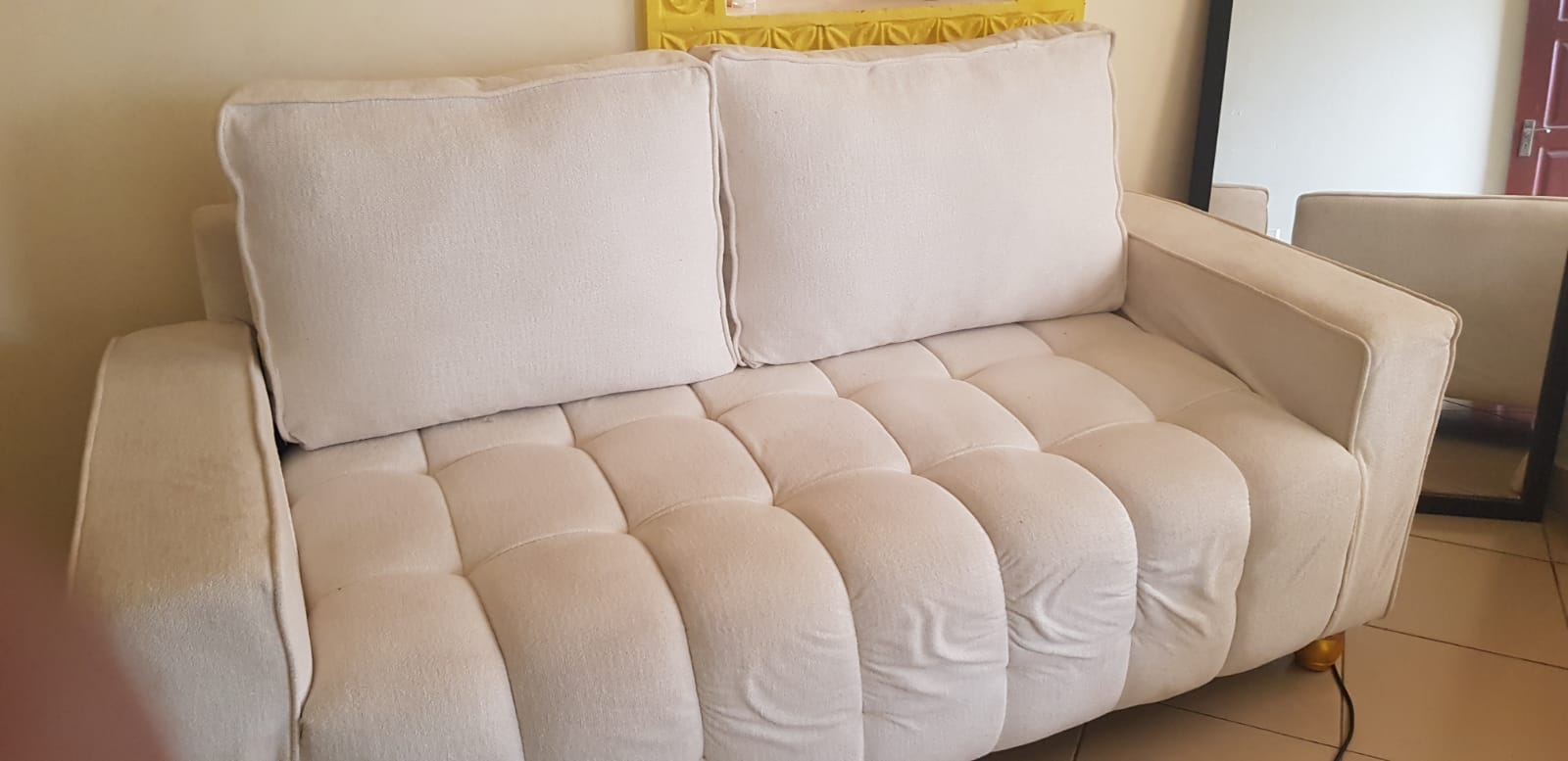 Professionally cleaned white couch in Mombasa home - residential cleaning service
